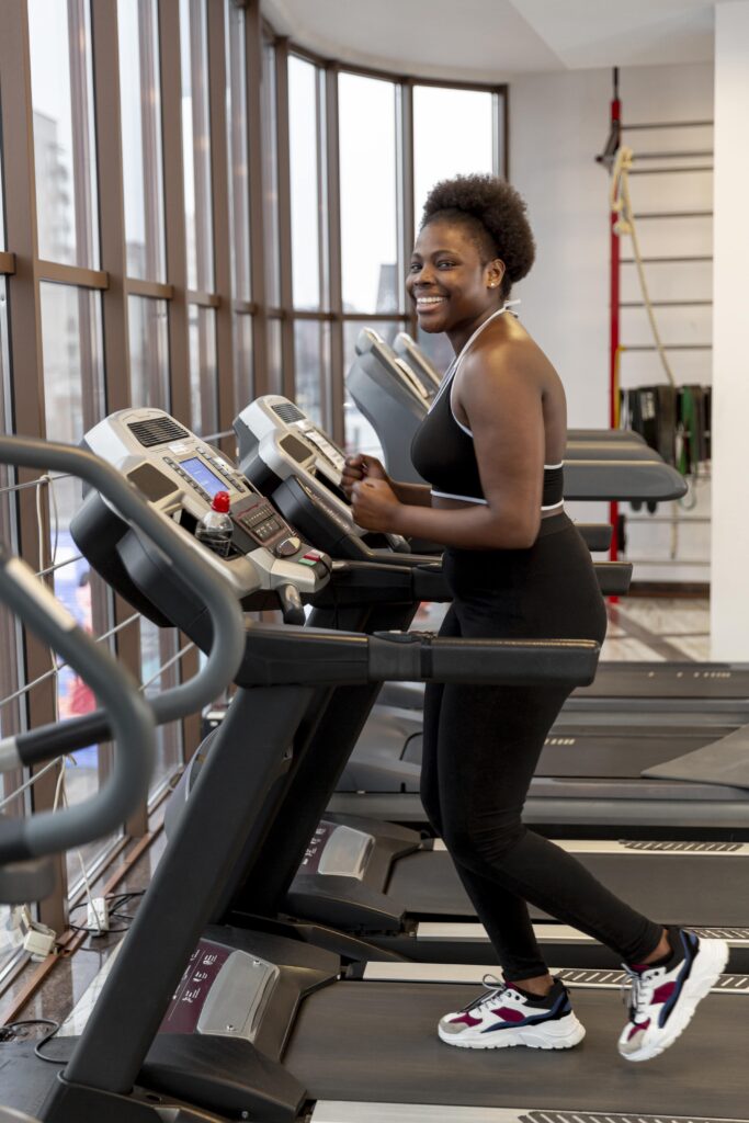 side view young woman treadmill min